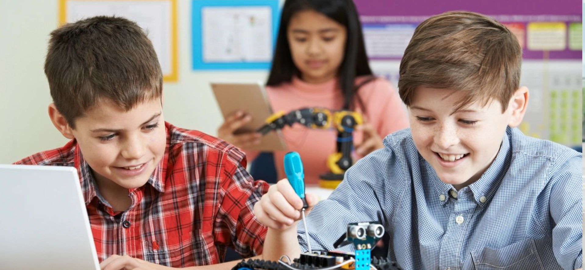 Students building a robot in class.